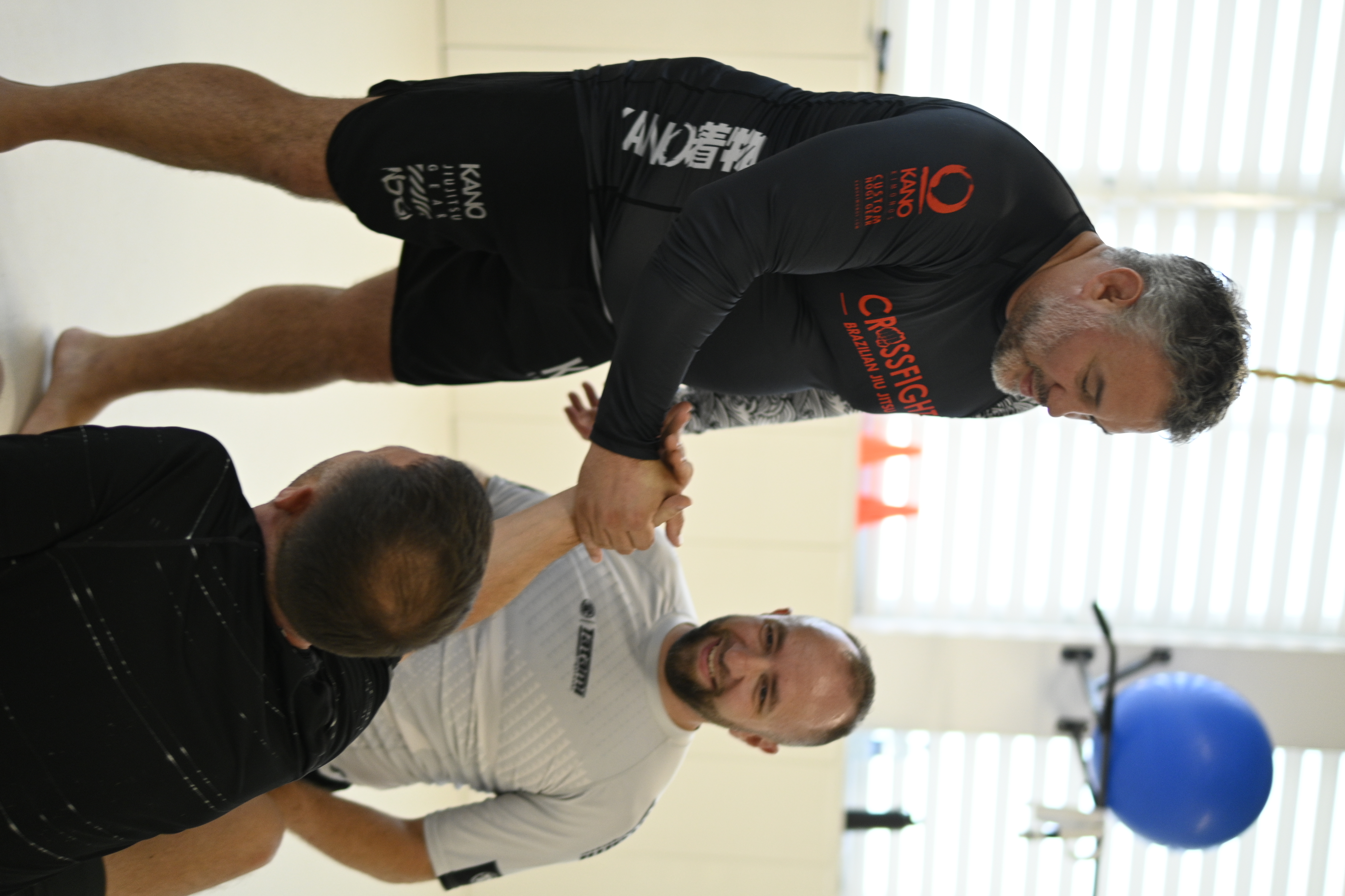 Adult students helping each other up after rolling